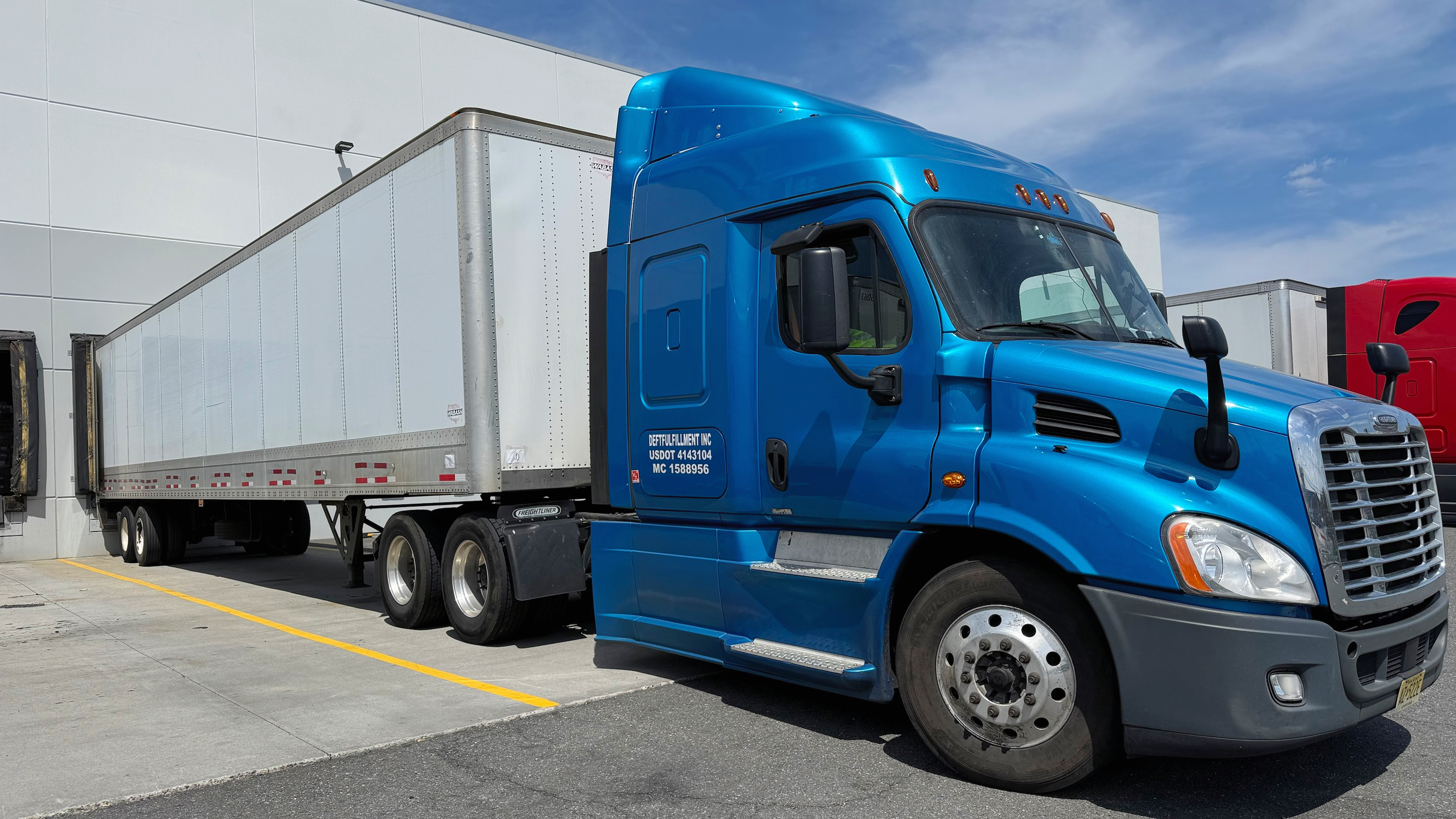 Deftfulfillment truck fleet lined up at the warehouse yard